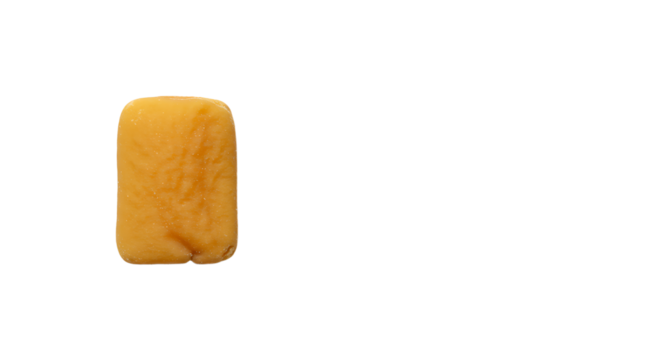 Chewy taffy candy piece on white background, studio shot close up