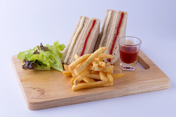 Ham and ketchup sandwich, served with crispy yellow french fries, green salad, red ketchup, placed...