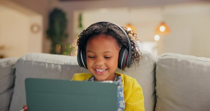 Girl, child and tablet for music in home, online education and listening to podcast for learning. Female person, kid and playing games in living room for mind development, happy song and streaming
