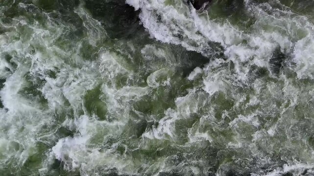 Aerial drone view of the rushing rapids in the white water of the Wenatchee river in Washington state. The Pacific Northwest nature is powerful, exciting, and dangerous. 