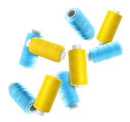 Spools of light blue and yellow sewing threads falling on white background