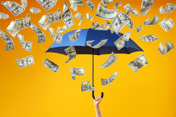 Money rain. Woman with umbrella under falling dollar banknotes on orange background, closeup