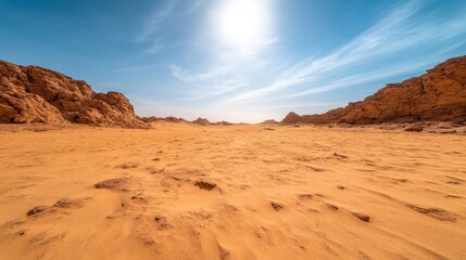 An expansive view of a vast desert horizon under a bright blue sky conveys feelings of isolation and the endless possibilities that nature presents to the adventurous spirit.