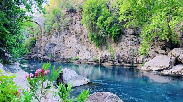 The historic Roman Oluk Bridge, or Eurymedon Bridge, in Koprulu Canyon. The ancient Roman bridge was built across the turquoise Kopruchai River in emerald green color.The National Park.Antalya,Turkey