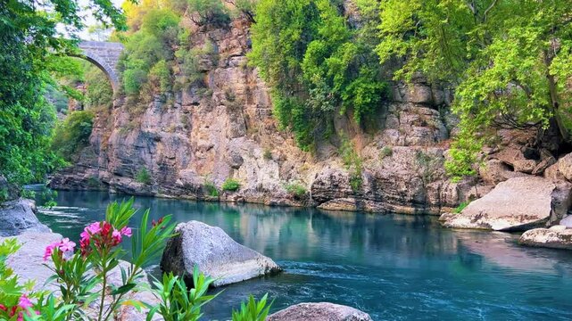The historic Roman Oluk Bridge, or Eurymedon Bridge, in Koprulu Canyon. The ancient Roman bridge was built across the turquoise Kopruchai River in emerald green color.The National Park.Antalya,Turkey