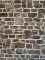 Old church wall with random handmade bricks and masonary old surface