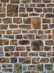 Old church wall with random handmade bricks and masonary old surface