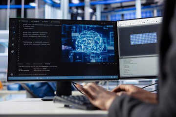 Engineer coding AI powered software at desk in solar energy plant, optimizing performance. Technician integrating artificial intelligence in photovoltaics factory production to enhance efficiency