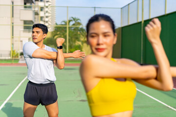Healthy wellness Asian man and woman sport training fitness workout exercise at stadium gym. Young...