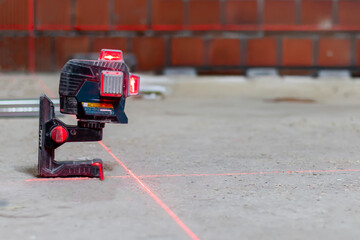 Laser level for setting the exact level at construction site. Modern tools for construction work.