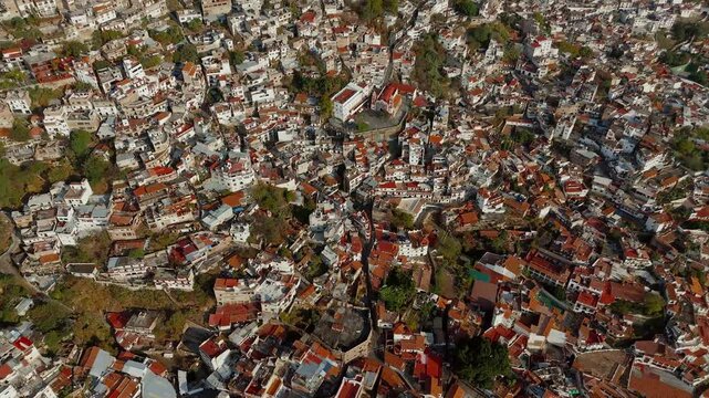 Panoramic view of Taxco de Alarcon in Mexico. Drone camera descends from high altitude to a church