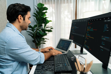 Smart IT developer working software development coding on laptop, creating application program...