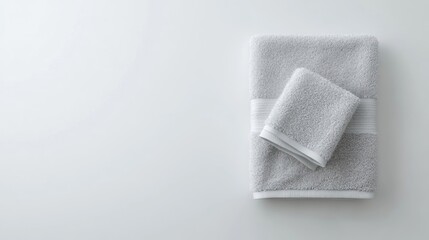 Obraz premium Soft Gray Towels Stacked on a Minimalist Background for Relaxation