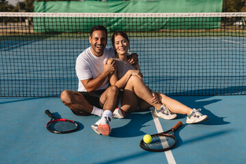 Two tennis players in action on the court with rackets, playing a competitive match