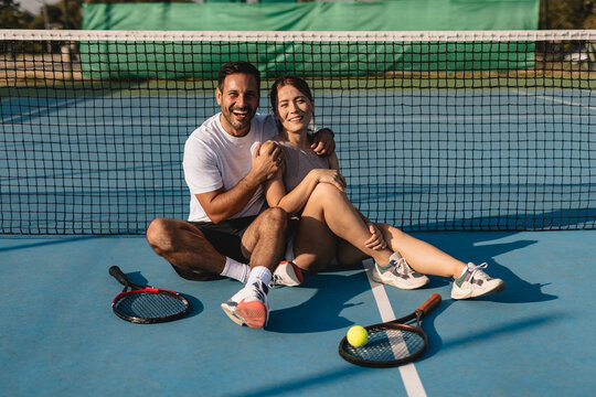 Two tennis players in action on the court with rackets, playing a competitive match