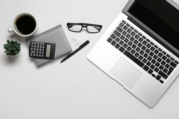 Composition with laptop, coffee and calculator on grey background