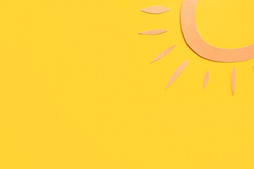 Paper sun on yellow background