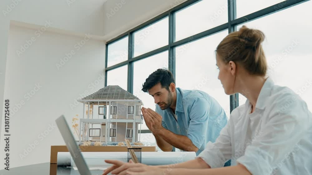 Poster professional engineer measure model while telling coworker about house design. young smart architect