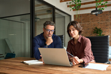 Busy business woman and man executive team people working on laptop in office. Two company managers...