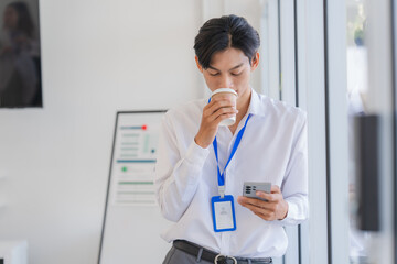Young Professional with Coffee and Mobile Phone