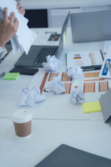 Overwhelmed Business Workspace with Crumpled Paper