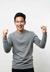 Fototapeta premium Joyful Asian Man Celebrating Success, Triumphant Expression, Portrait Photography