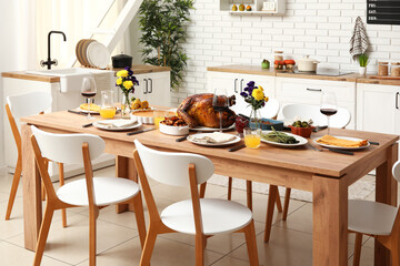 Festive dining table with tasty food for Thanksgiving Day in kitchen