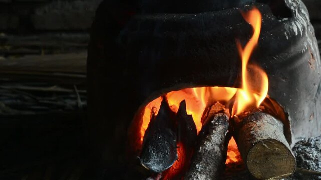 Traditional cooking with a stove made of clay and a hot pot boiling water