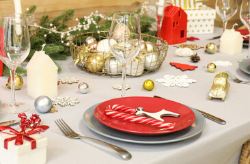 Festive table setting with beautiful Christmas decorations, closeup
