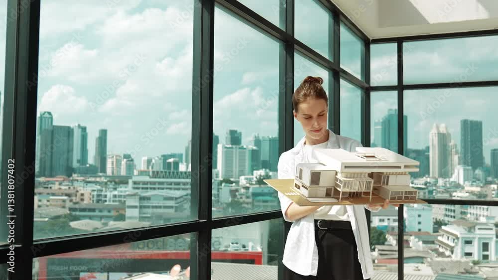 Poster smart happy beautiful manager check house model by turning left side and right side. professional ma