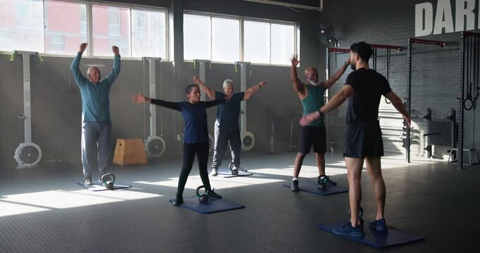 Fitness, gym and personal trainer with senior people for training, exercise and warm up for workout. Sports, stretching and coach with mature men and women for wellness, health or cardio for mobility