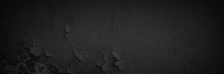 Dark wide panoramic background. Peeling paint on a concrete wall. Dark grunge texture of old...