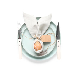 Beautiful table setting with Easter egg and feather on white background