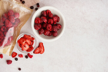 Composition with tasty freeze-dried berries on light background