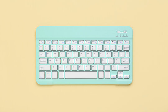 Stylish cyan keyboard on beige background