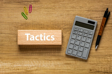 There is wood block with the word Tactics. It is as an eye-catching image.