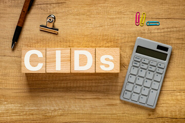 There is wood cube with the word CIDs. It is an abbreviation for Climatic impact-drivers as...