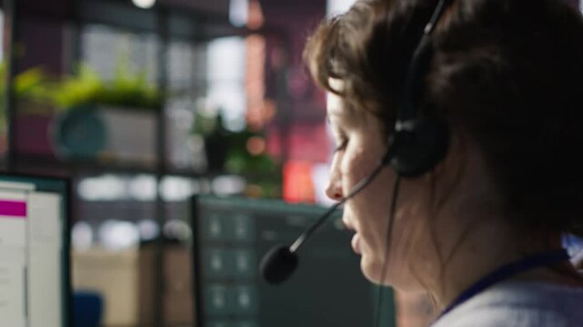 Call center agent uses AI chatbot on laptop to provide quick and accurate replies to common customer questions. Customer service worker generates automated responses using AI LLM on notebook, camera A