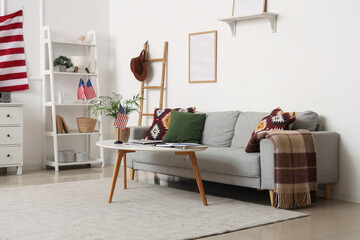 USA flags, table and comfortable sofa in interior of living room