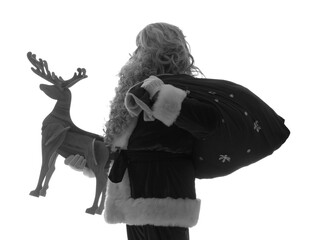 Silhouette of Santa Claus with bag of gifts and wooden reindeer on white background