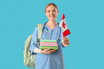 Female medical student with books and flag of Canada on blue background