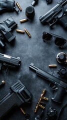 Assorted firearms and ammunition laid out on a dark surface