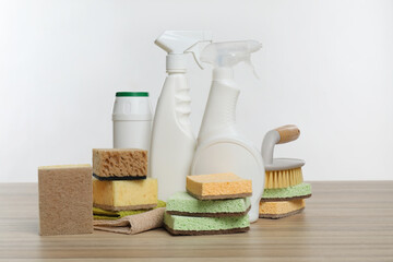 Eco-friendly cleaning products and supplies on wooden table