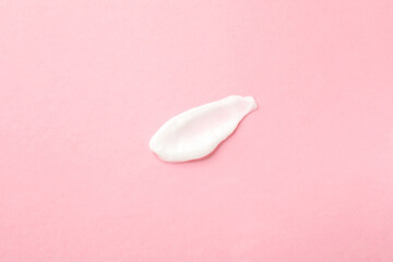 Sample of body cream on pink background, top view
