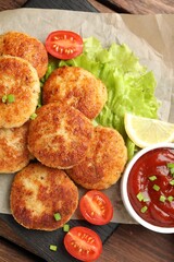Delicious patties served on wooden table, top view