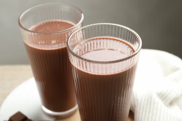 Tasty chocolate milk in glasses on table, closeup