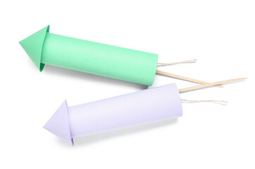 Green and purple firework rockets on white background