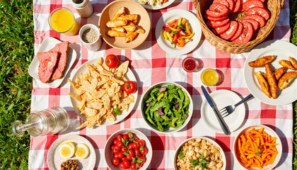 Fresh picnic spread with assorted foods on checkered tablecloth

