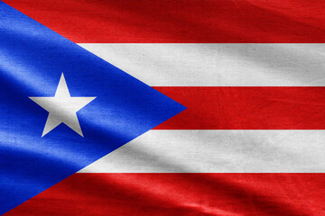 National flag of Puerto Rico waving with realistic fabric texture, blue triangle with white star and horizontal stripes.