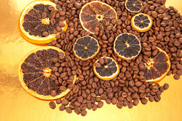 Warm-toned coffee beans and dried orange slices on a reflective golden backdrop, ideal for food and...